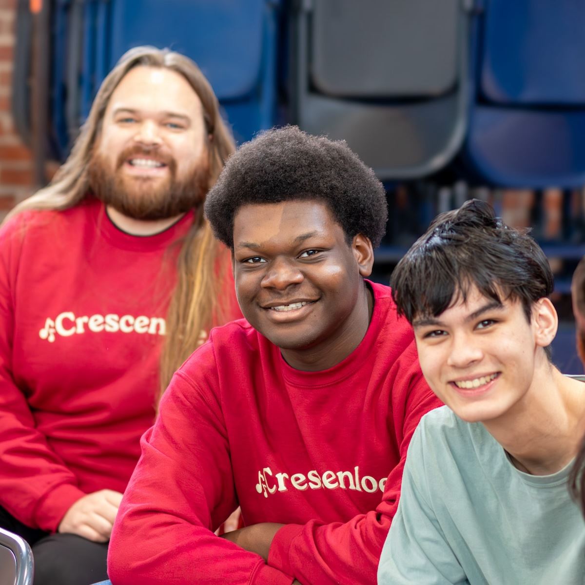  Students and a teacher smile for the camera